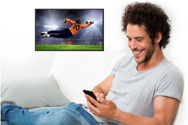 Man watches football game from mobile to TV